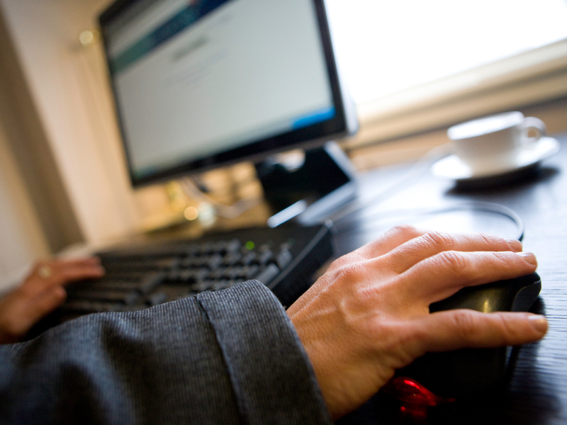 Person using a mouse at a computer